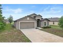 Well-maintained single-story home with neutral tones and a spacious driveway at 269 Fig Ct, Kissimmee, FL 34759