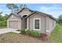 Attractive home exterior with landscaping, showcasing a well-manicured front yard at 269 Fig Ct, Kissimmee, FL 34759
