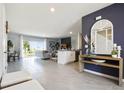 Spacious living area showcasing an open floor plan with tile floors, backyard view, and stylish decor at 2710 Golden Trout Ln, Edgewater, FL 32141