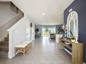 Elegant entryway featuring neutral walls, decorative mirror, and a seamless transition to the living area at 2712 Golden Trout Ln, Edgewater, FL 32141