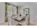 Beautifully staged dining room with neutral tones, modern furniture, and ample natural light at 279 Wisteria Ct, Deltona, FL 32738