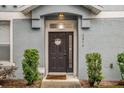 Inviting front door with a welcoming wreath, flanked by green bushes, and the house number displayed at 2810 San Jacinto Cir # 2810, Sanford, FL 32771
