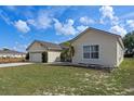 A charming, single-story home with a well-manicured lawn and attached two-car garage at 322 Huron Dr, Kissimmee, FL 34759