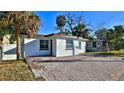 Charming home showcasing a brick driveway, lush greenery, and a well-maintained exterior at 326 Hobart Ave, Daytona Beach, FL 32114