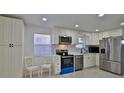 Well-lit kitchen featuring stainless steel appliances, white cabinets, and modern countertops at 326 Hobart Ave, Daytona Beach, FL 32114