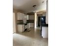 Functional kitchen with white cabinets, essential appliances, and access to a dining area at 42 Banyan Pass, Ocala, FL 34472