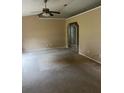 Spacious living room featuring neutral walls and ample natural light from a large window at 42 Banyan Pass, Ocala, FL 34472