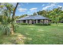 Charming single-story home with lush landscaping and large front yard at 433 Tangerine Ave, Lake Helen, FL 32744
