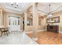 Welcoming foyer with marble tile, an ornate front door, and wood flooring leading to living areas at 433 Tangerine Ave, Lake Helen, FL 32744