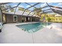 Enclosed pool area with screen enclosure, patio, and well-maintained landscaping around the home at 433 Tangerine Ave, Lake Helen, FL 32744