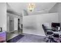 Bright living room featuring stylish decor, a comfortable workspace, and a view into adjacent rooms at 460 Flamingo Ct, Kissimmee, FL 34759