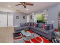 Comfortable living room featuring stylish gray couches, modern rug, and bright window views at 4843 Pierce Arrow Dr, Apopka, FL 32712