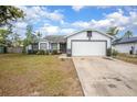 Charming single-Gathering home featuring two-tone paint scheme, an attached garage and landscaping at 528 Courtland Blvd, Deltona, FL 32738