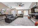 Comfortable living room with gray, leather sectional, ceiling fan, and stylish decor at 528 Courtland Blvd, Deltona, FL 32738