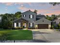 Charming two-story home with manicured lawn and beautiful stone accents, creating inviting curb appeal at 557 Lake Cove Pointe Cir, Winter Garden, FL 34787