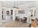 Open-concept living area with comfortable seating, chandelier lighting, and seamless transition between spaces at 557 Lake Cove Pointe Cir, Winter Garden, FL 34787