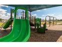 Community playground featuring swings and a slide in a safe, wood-chipped play area at 6055 Vision Rd, St Cloud, FL 34771