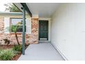 A front door and entryway featuring brick and painted finishes at 635 San Lanta Cir, Sanford, FL 32771