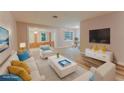 Bright, virtually staged living room with light hardwood floors, comfortable seating, and a modern entertainment center at 635 San Lanta Cir, Sanford, FL 32771
