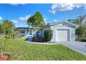 Inviting single-story home showcasing a well-maintained lawn, new paint, and an attached single-car garage at 642 Carver Dr, Lake Wales, FL 33853