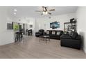 Open concept living room with hardwood floors, ceiling fan, a dining area, and lots of natural light at 725 N Grandview Ave, Daytona Beach, FL 32118