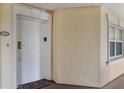 Welcoming condo entrance with a white door, side window, and unit number, creating a private and secure entry at 7660 Whisper Way # 402, Reunion, FL 34747