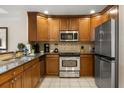 Modern kitchen featuring stainless steel appliances, granite counters, and ample cabinet space for all your cooking needs at 7660 Whisper Way # 402, Reunion, FL 34747