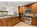 Well-equipped kitchen with stainless steel appliances, granite countertops, and tile flooring for style and functionality at 7660 Whisper Way # 402, Reunion, FL 34747