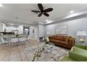 Open-concept living room featuring a comfortable sofa, modern furnishings, and neutral decor at 8122 Roseville Rd, Davenport, FL 33896