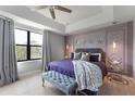 Main bedroom showcasing modern wall decor, a plush bed, and a cozy sitting bench at 8122 Roseville Rd, Davenport, FL 33896
