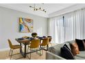 Dining room has modern lighting, a dining table set for eight, and access to the patio at 8124 Roseville Rd, Davenport, FL 33896