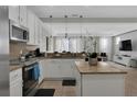 Bright, modern kitchen features granite countertops, island, and stainless steel appliances at 8124 Roseville Rd, Davenport, FL 33896
