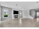 Spacious living room with tile flooring and a modern fireplace with TV, offering a clean and open design at 8226 Nemours Pkwy, Orlando, FL 32827
