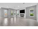 Open living room featuring a sleek fireplace, recessed lighting, and neutral tones throughout at 8226 Nemours Pkwy, Orlando, FL 32827