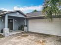 Single-story house with blue exterior paint, decorative stars, well-lit front porch, and a two-car garage at 8606 Port Said St, Orlando, FL 32817