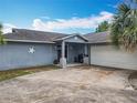 Attractive single-story home features blue exterior paint, decorative stars, front porch and an attached garage at 8606 Port Said St, Orlando, FL 32817