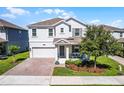Charming two-story home with a brick-paved driveway and a cozy front porch at 1123 Dora Parc Ln, Mount Dora, FL 32757