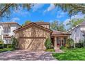 Charming home with a red brick driveway, a red tile roof, and shuttered windows at 1166 Adair Park Pl, Orlando, FL 32804