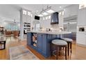 Modern kitchen featuring a large center island, white cabinets, and hardwood floors at 1166 Adair Park Pl, Orlando, FL 32804