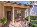 Inviting front porch with seating area featuring two chairs and a quaint outdoor setting at 1166 Adair Park Pl, Orlando, FL 32804