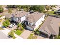 An aerial view showcases the house, highlighting its roof, landscaping, and proximity to neighboring homes at 1311 Arisha Dr, Kissimmee, FL 34746