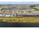 Backyard aerial view with screened lanais and pools overlooking scenic lake, plus community view at 13462 Panama Beach Ct, Orlando, FL 32827