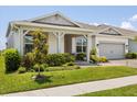 Well-maintained single-Gathering home with covered porch and lush landscaping at 13462 Panama Beach Ct, Orlando, FL 32827