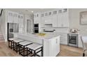 Bright kitchen featuring a center island with seating, stainless appliances, and lots of storage space at 13758 Tybee Beach Ln, Orlando, FL 32827
