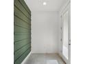 Bright entryway with a textured green accent wall and tile flooring at 14538 Orchid Island Dr, Orlando, FL 32827