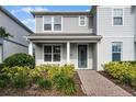 Inviting two-story home featuring a well-kept lawn and classic architectural details at 14538 Orchid Island Dr, Orlando, FL 32827