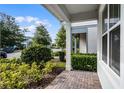 View of the well-kept landscaping and inviting front porch of a home at 14538 Orchid Island Dr, Orlando, FL 32827