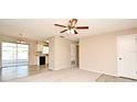Spacious living room featuring neutral paint, ceiling fan, carpeted and wood flooring at 1515 Pelican St, Longwood, FL 32750