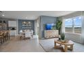 Open-concept living space with stylish furnishings, accent wall, adjacent dining area, and natural light at 219 Taylor Groves St, Lake Wales, FL 33853