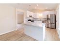 Stylish kitchen featuring white cabinetry, stainless steel appliances, and a marble-top island at 2486 Ainsworth Ave, Deltona, FL 32738